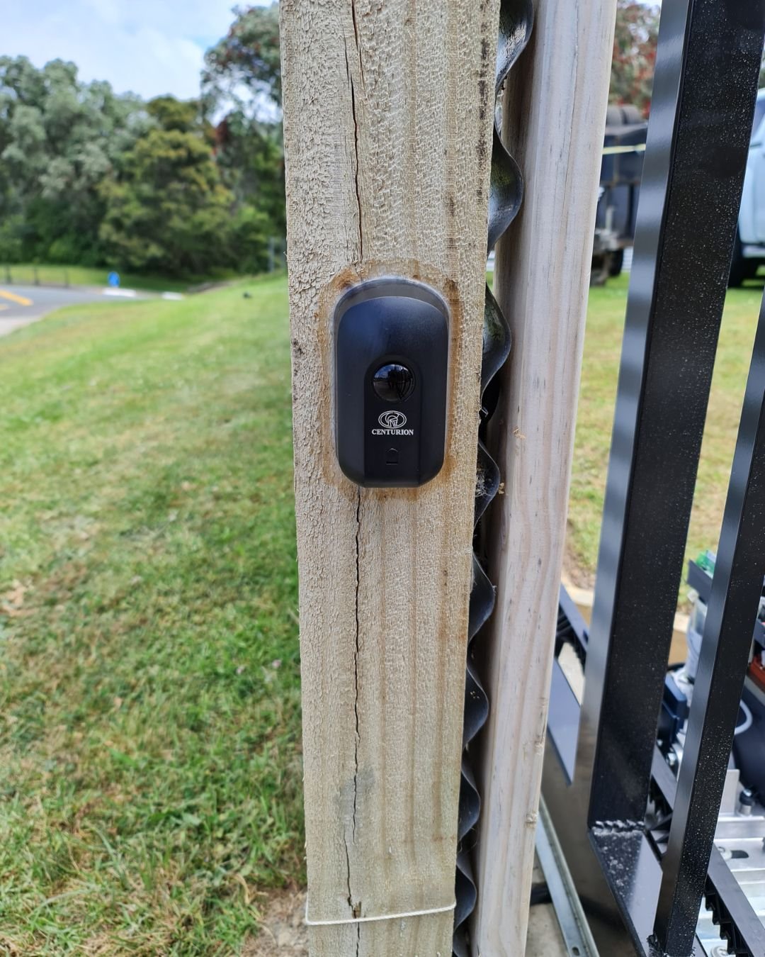 Wireless gate keypad mounted on a post at a residential driveway entrance on the Hibiscus Coast, Auckland