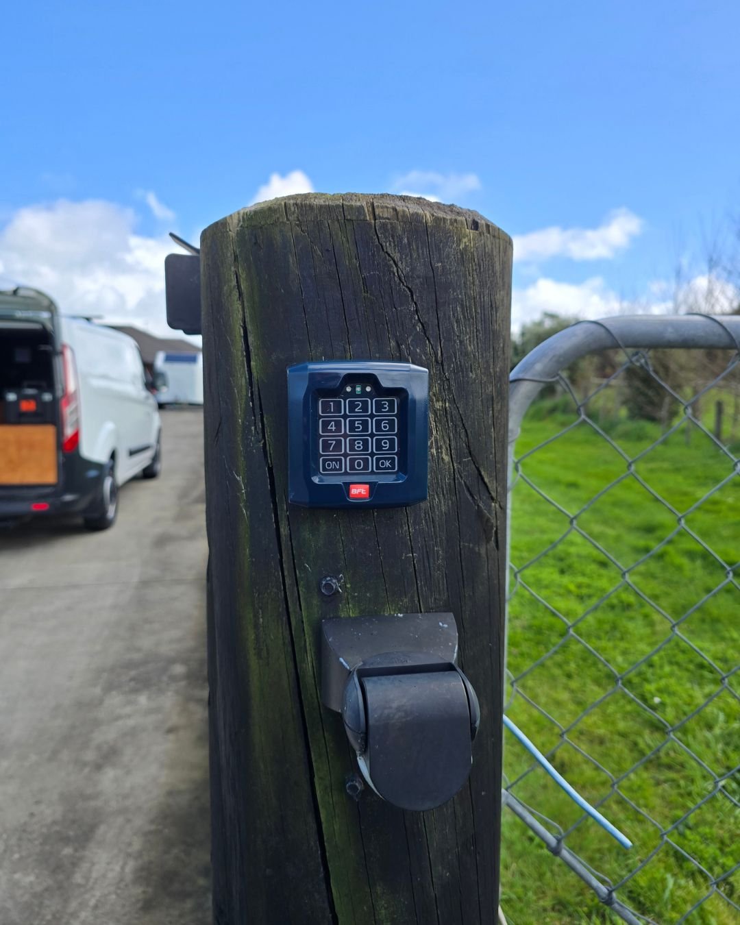 Gate access keypad on a timber post with the Personal Tech van parked on the driveway, Rodney Auckland