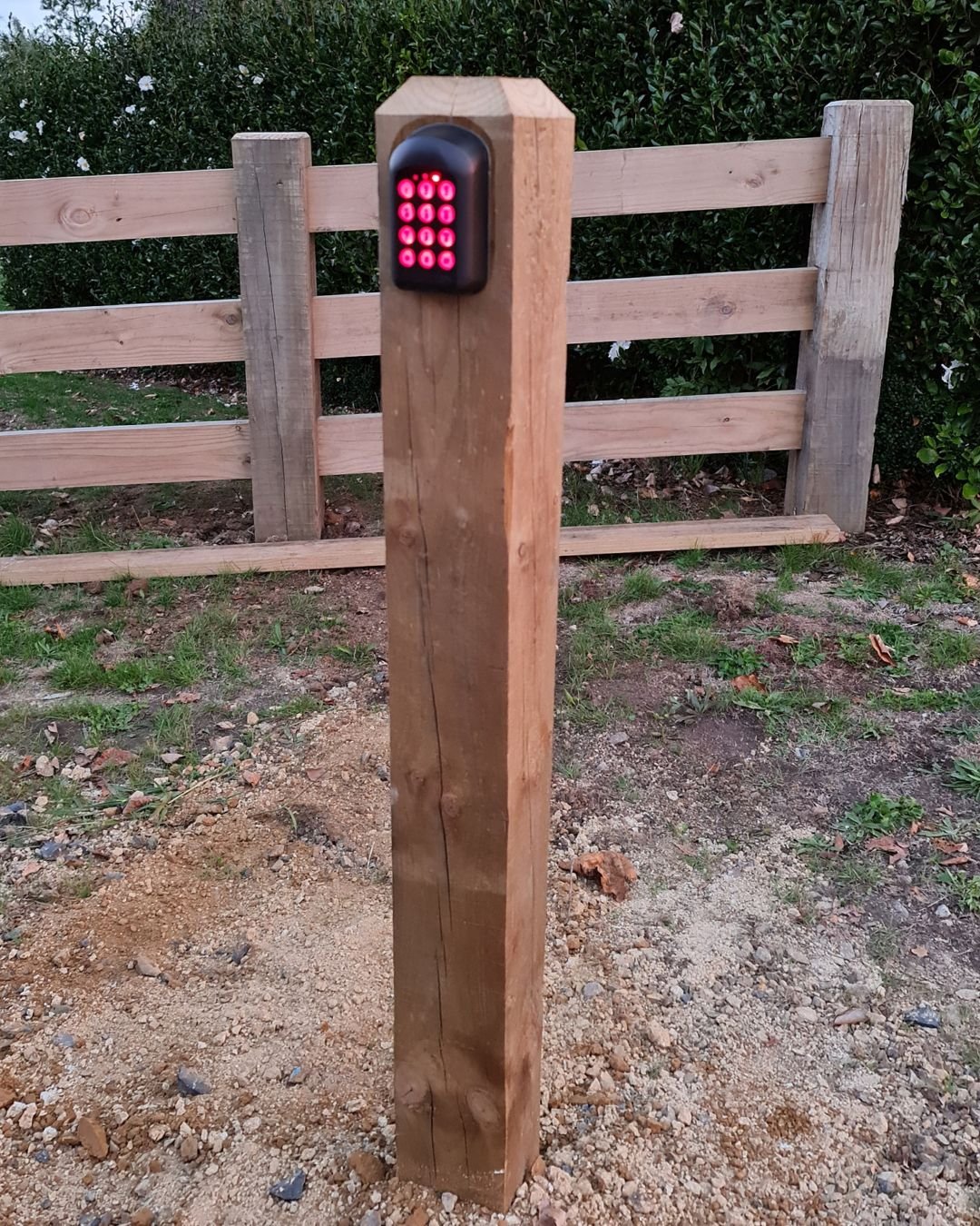 Backlit gate entry keypad mounted on a timber post at a rural driveway in Warkworth, Auckland