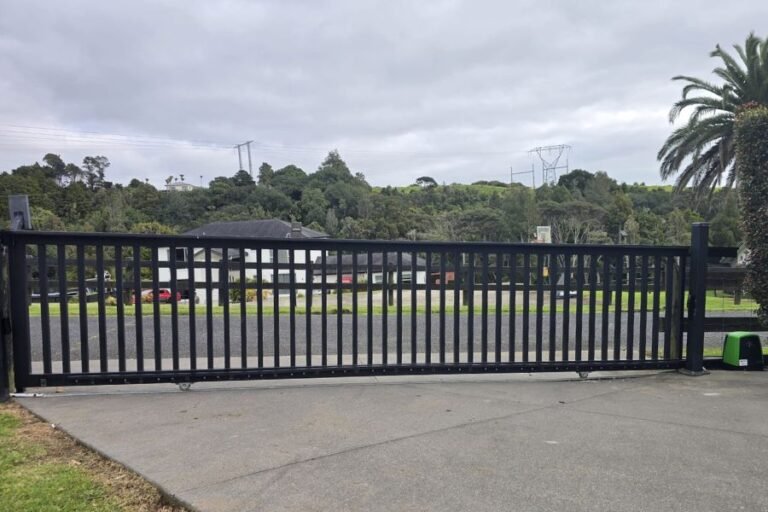 Long black aluminium sliding gate with a gate motor at a business premises in Albany on Auckland's North Shore