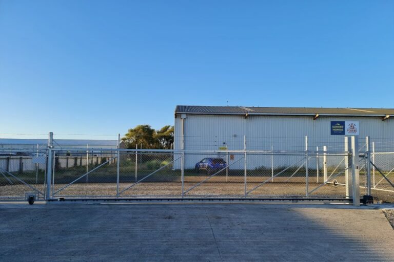 Automated galvanised mesh sliding security gate at a commercial waterfront yard in Gulf Harbour, Auckland